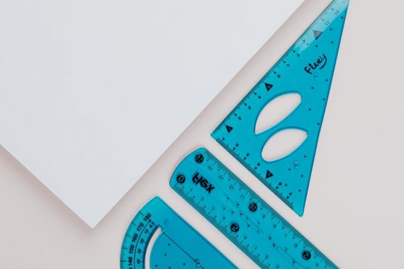 Close-up image of blue geometry tools on white background for educational use.